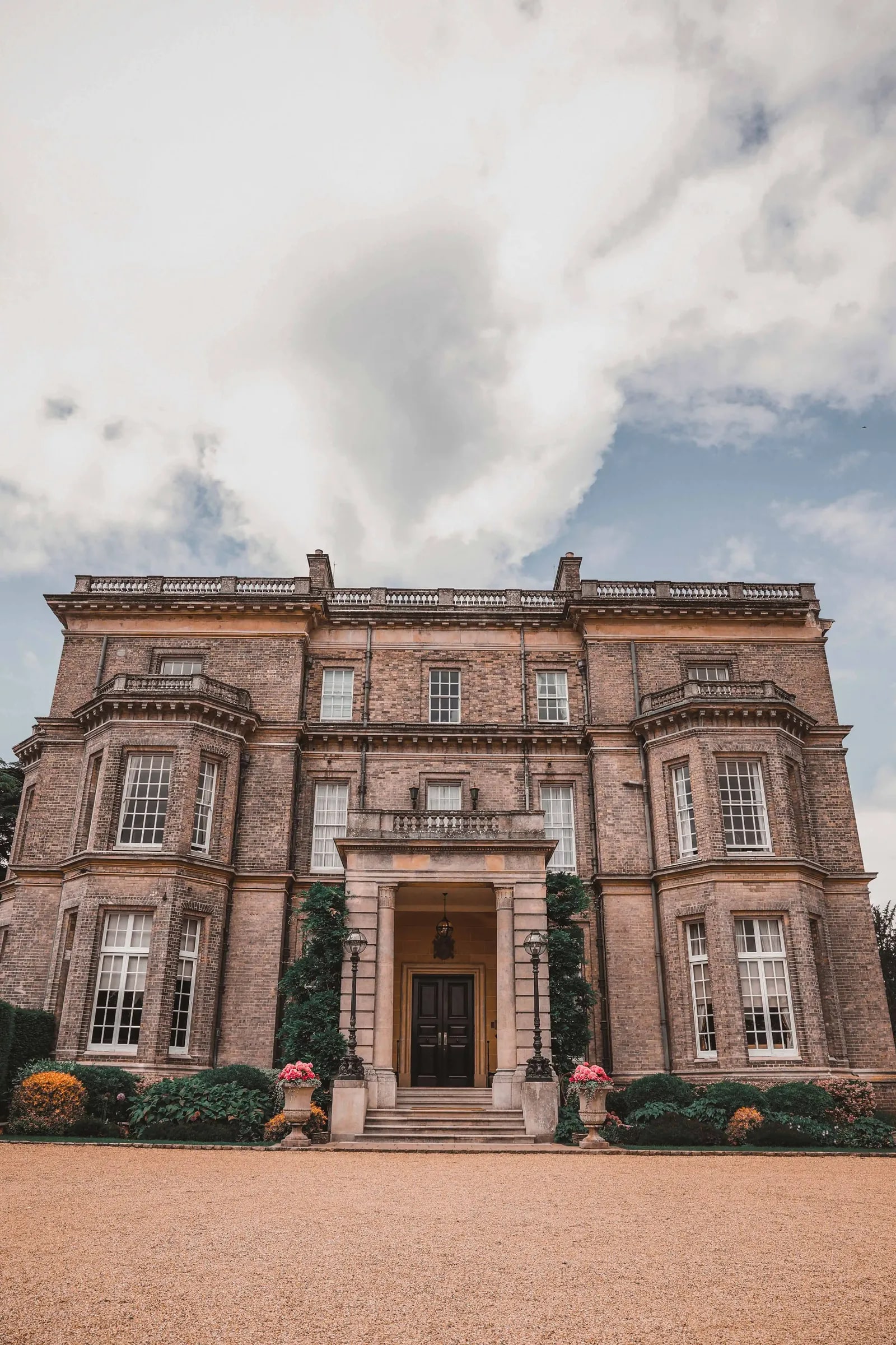 The full stone front of Hedsor House from the gravel drive