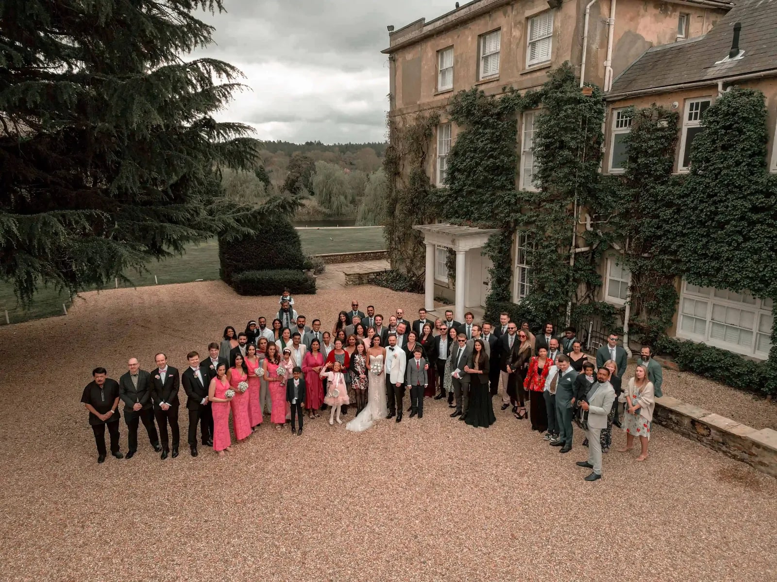 All the guests gathered on the drive, the valley beyond the house behind them
