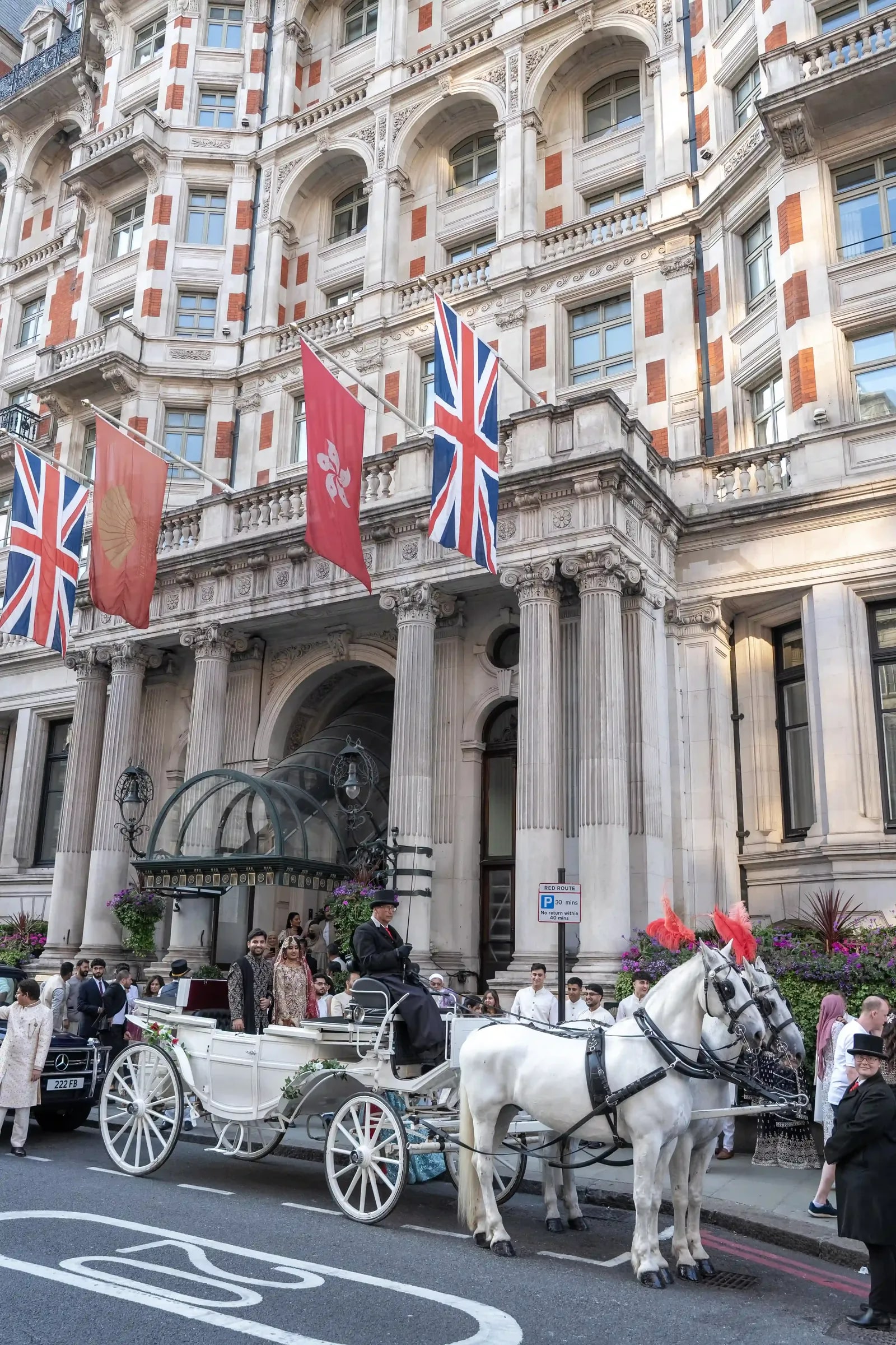 White horse-drawn carriage waiting outside the hotel on Knightsbridge