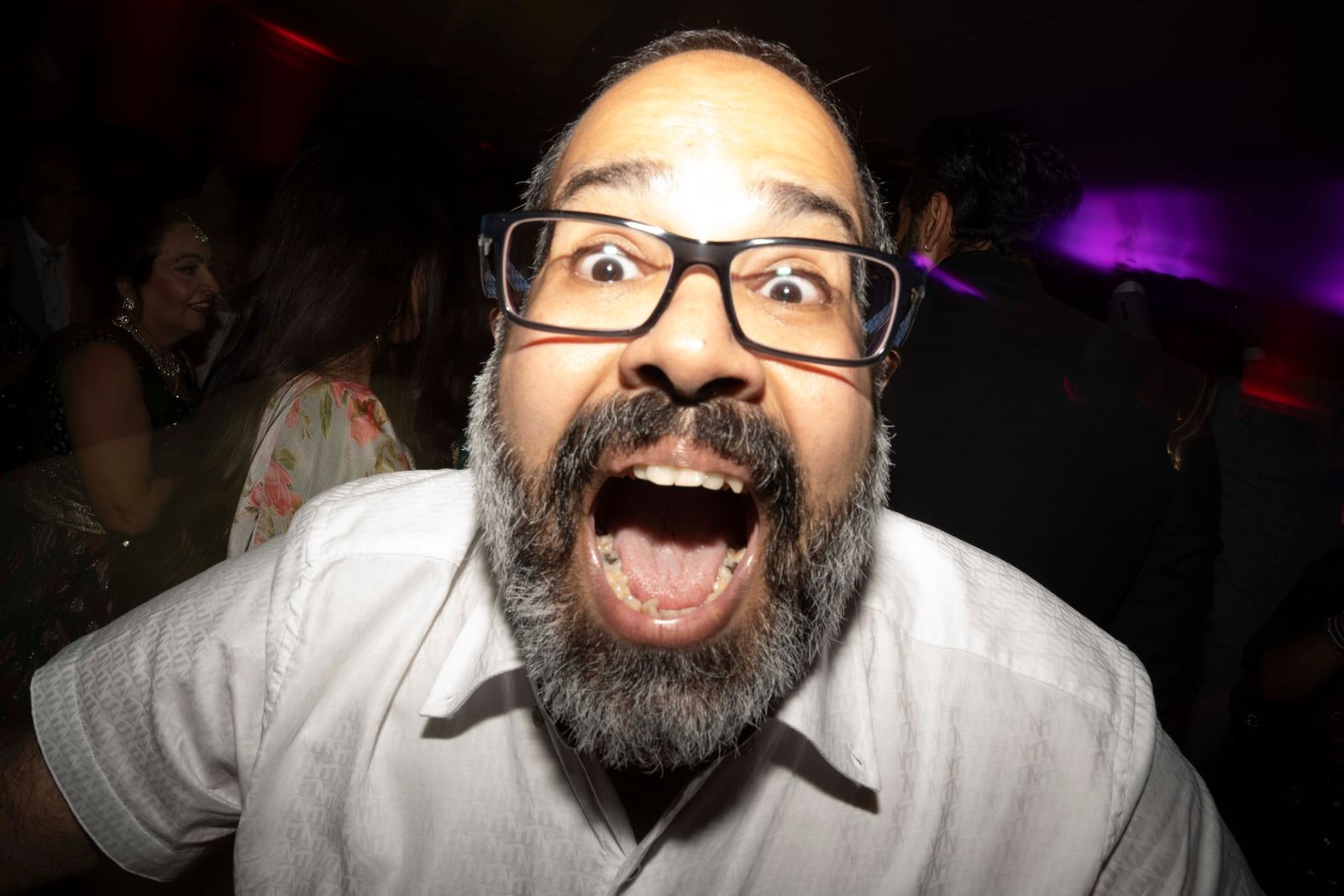 A guest pulling a face close to the camera on the dance floor