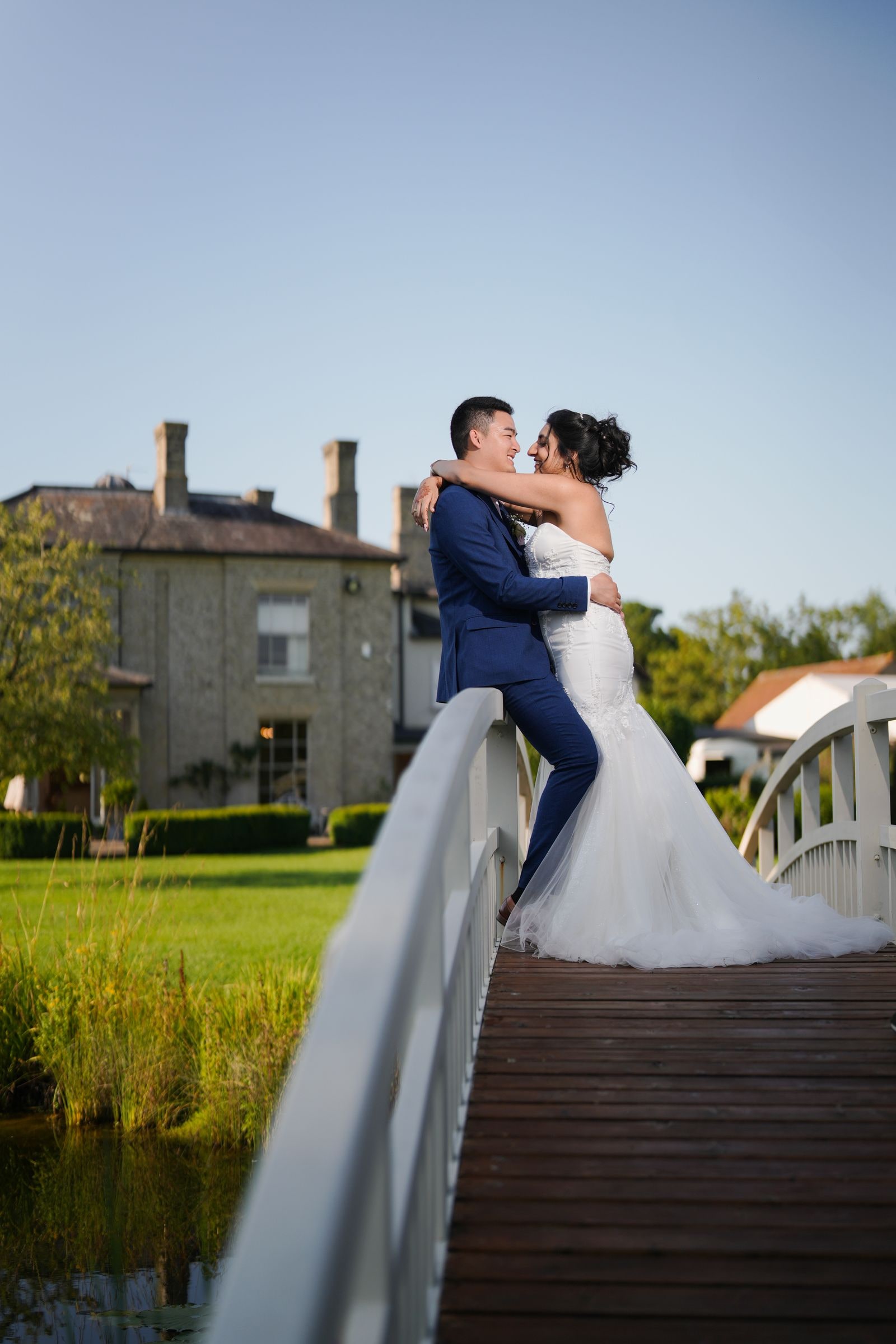Couple holding each other on the wooden bridge in evening light