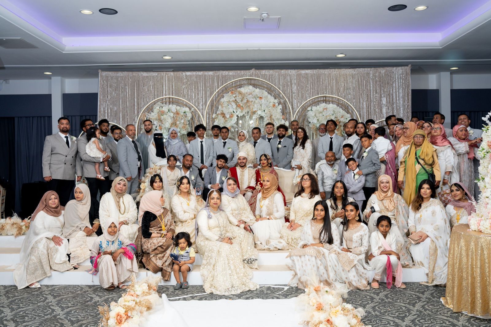 The whole family assembled on the stage for a group photograph, most dressed in cream
