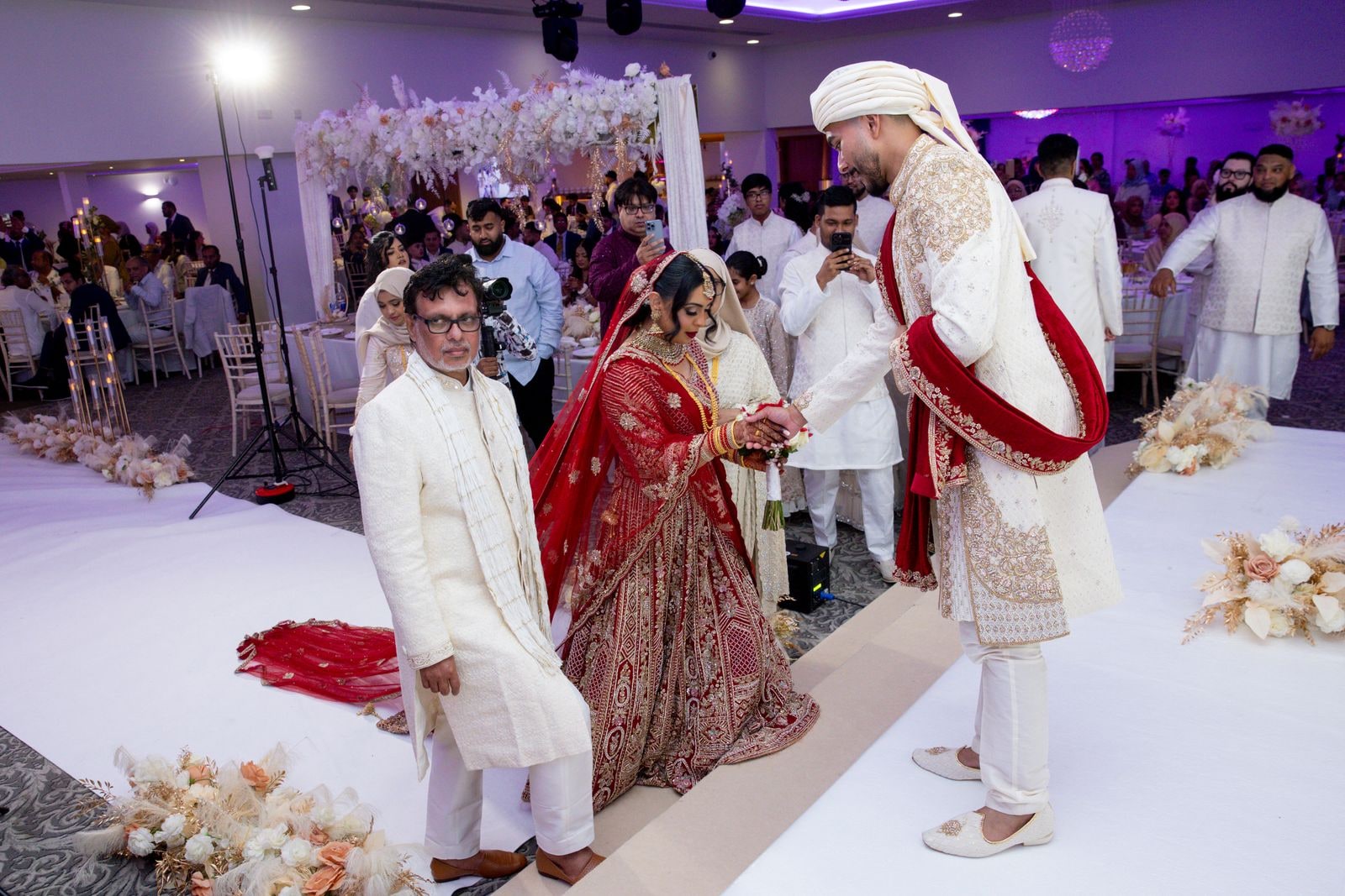 The bride handed over to her groom at the end of the aisle