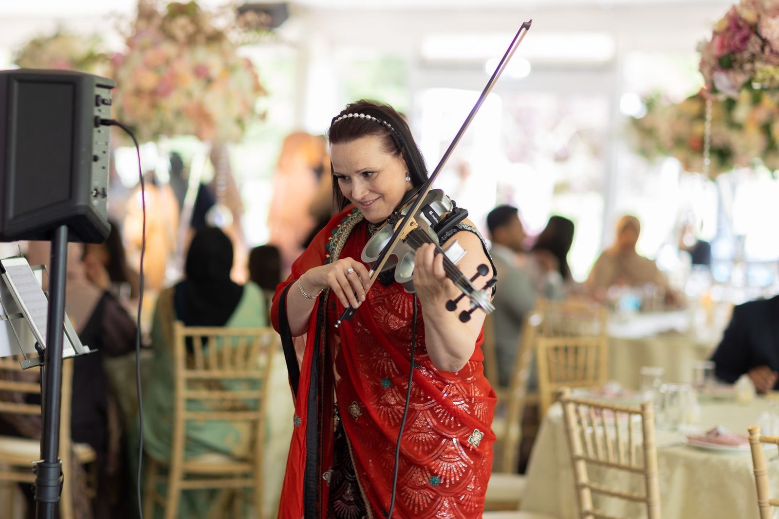Violinist in red playing for the guests during the reception
