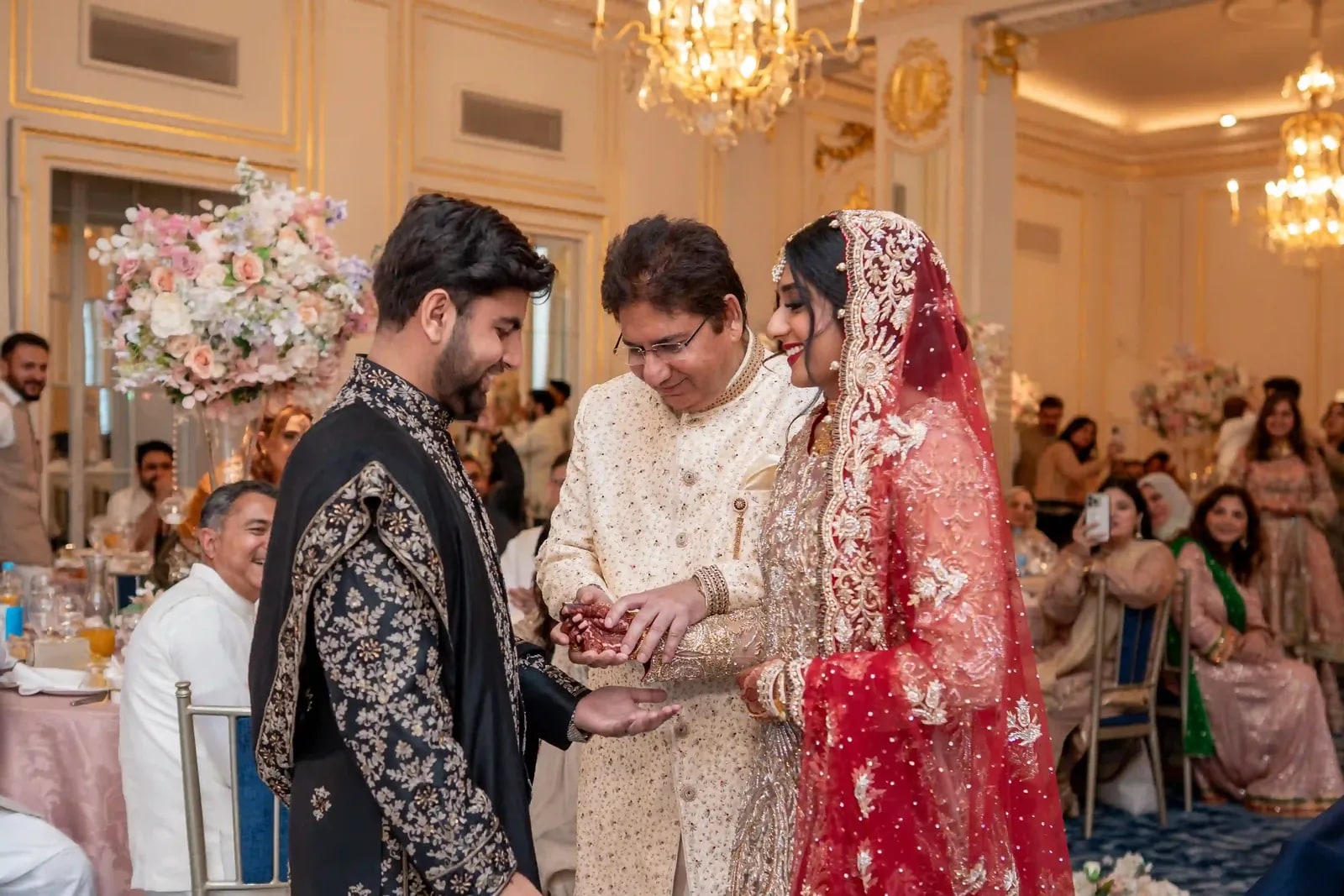 The bride's father joining her hand with the groom's during the ceremony