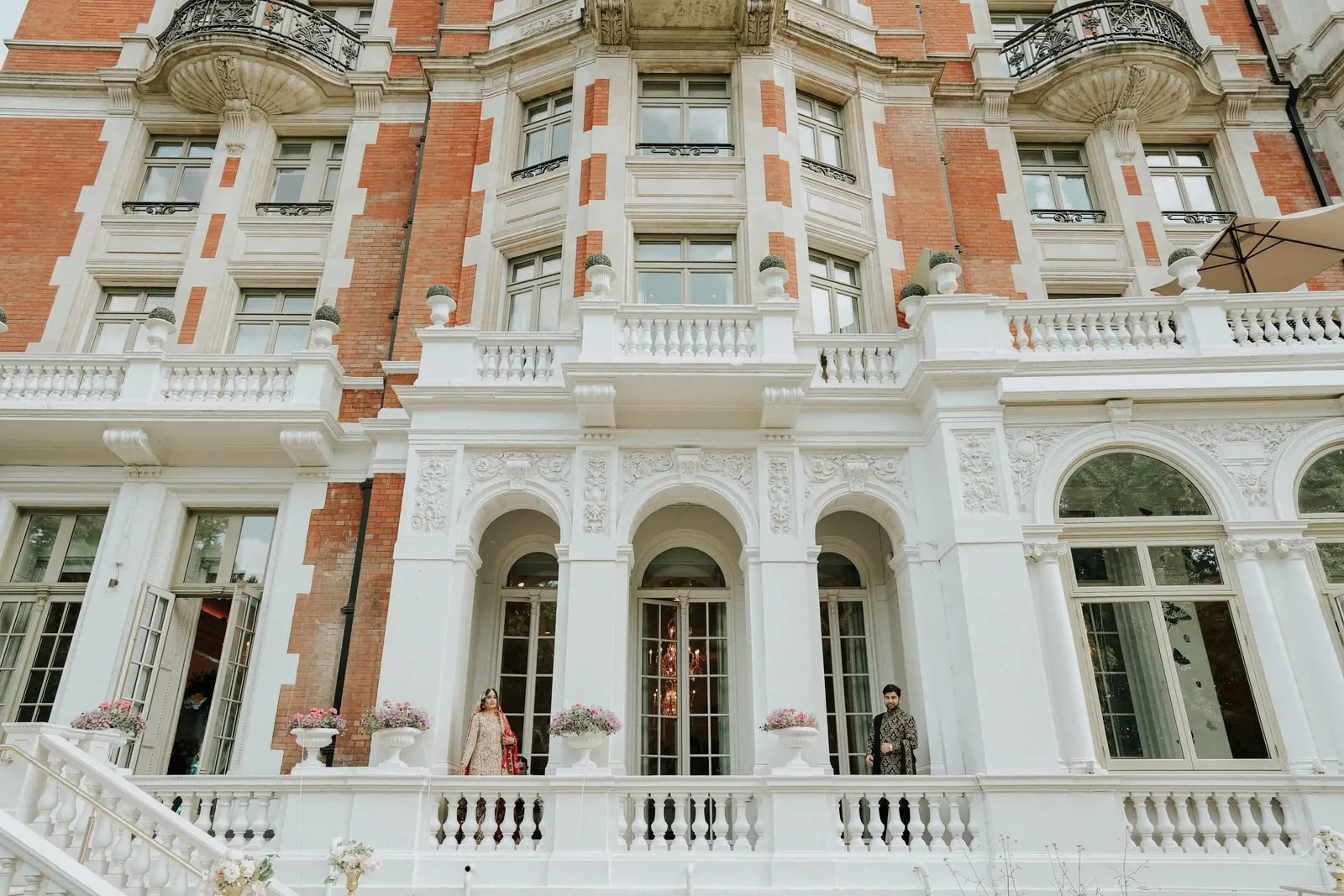 The white and red brick facade of the Mandarin Oriental seen from across the street