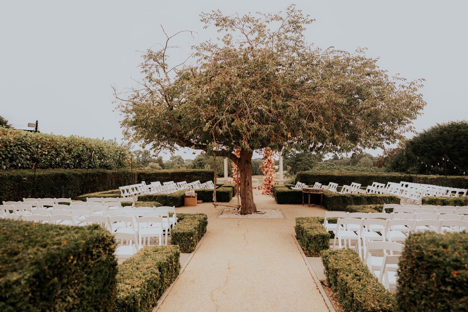The garden ceremony seen down the aisle, the flowered pavilion at the far end
