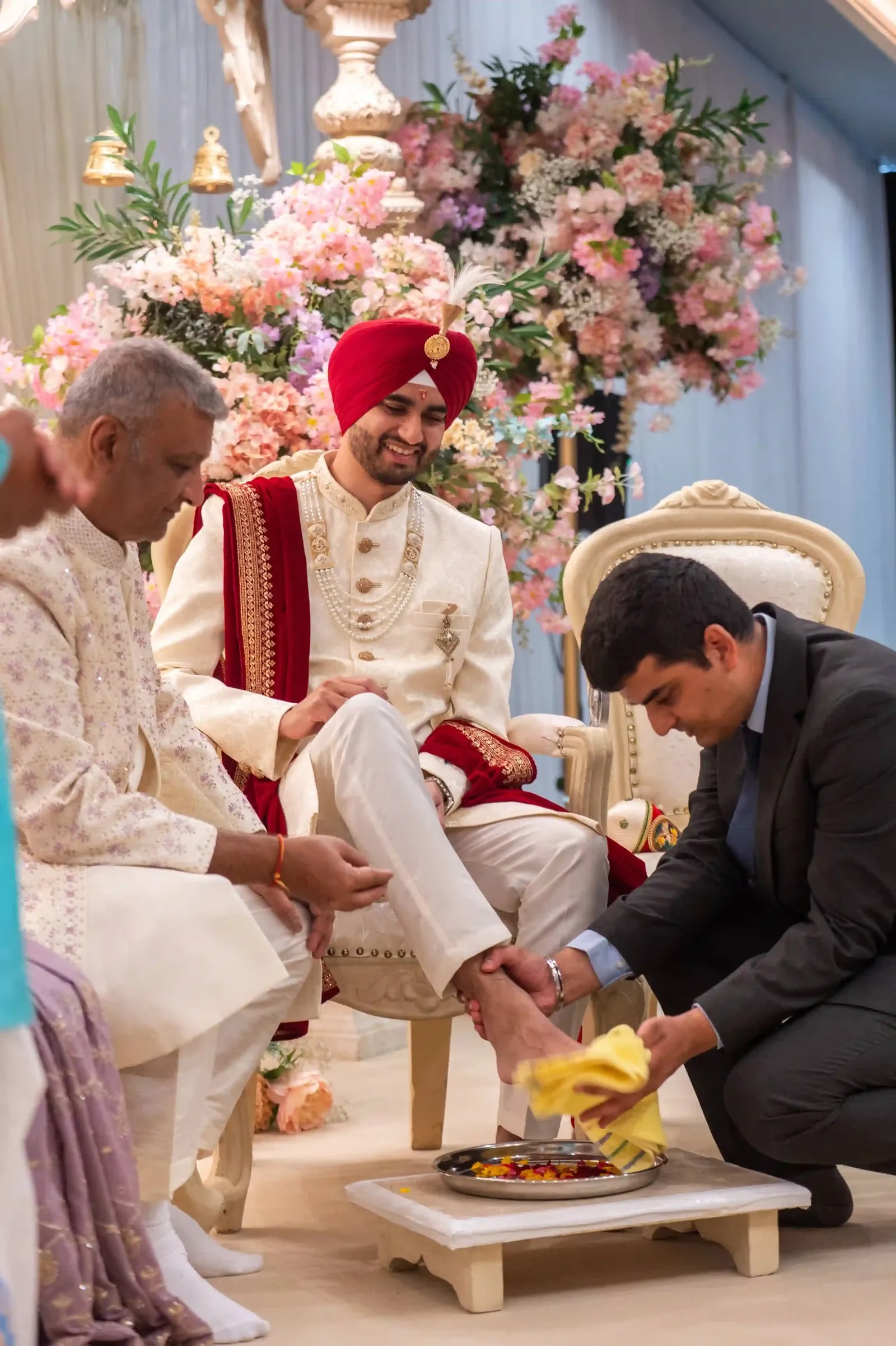The groom's feet being washed and dried during the welcome ritual