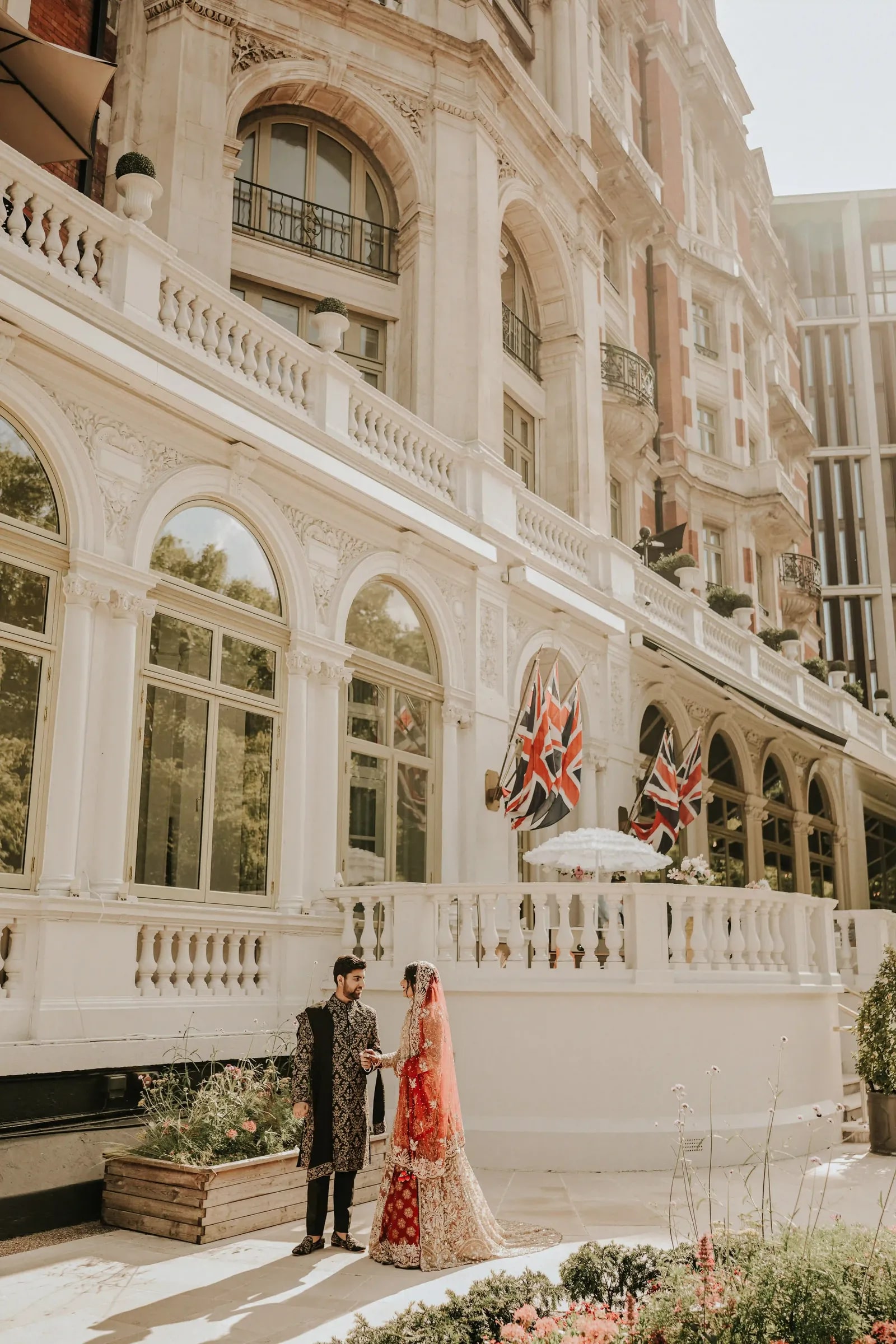 Couple walking the terrace along the white stone front of the hotel