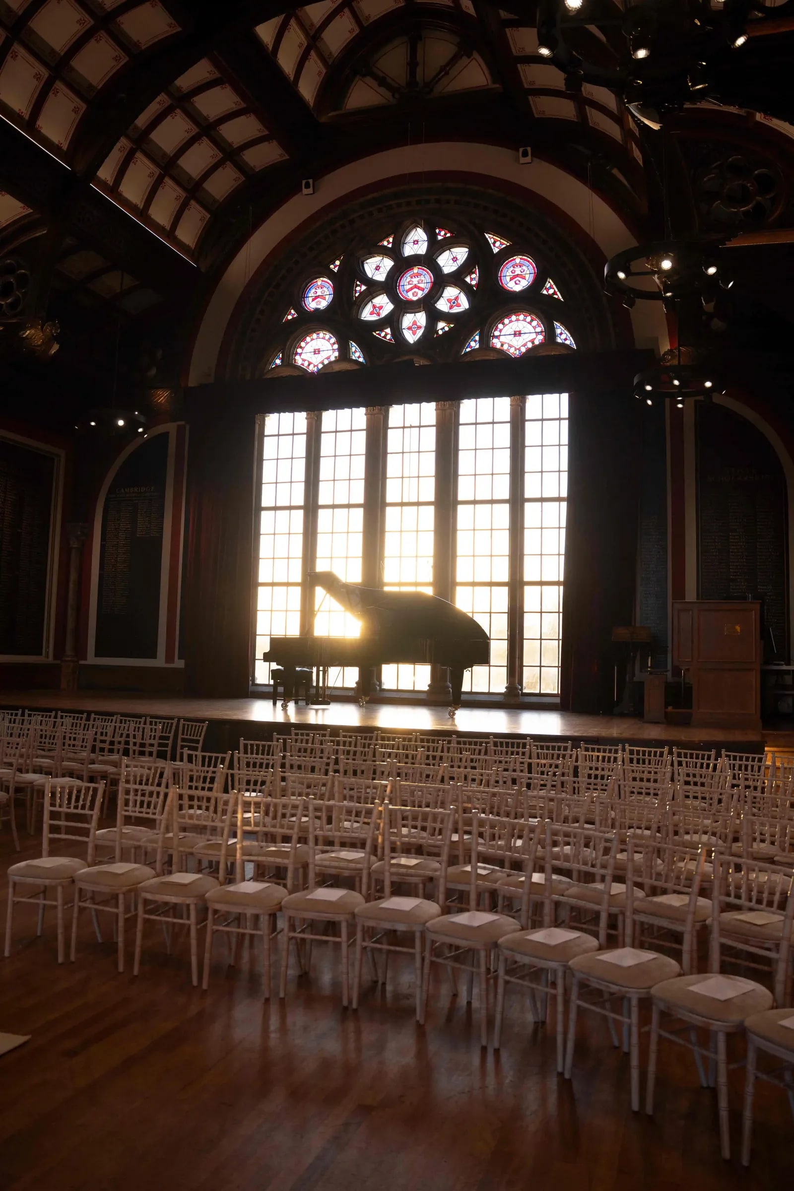 The hall before the ceremony, a grand piano beneath the rose window