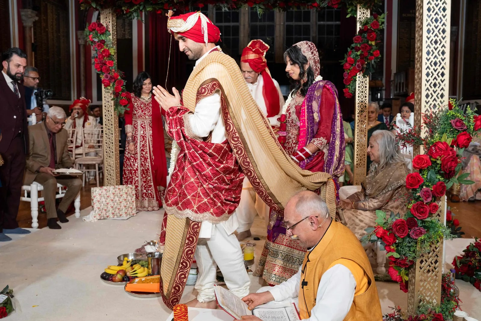 The couple circling the fire, her dupatta tied to his shawl, the priest reading