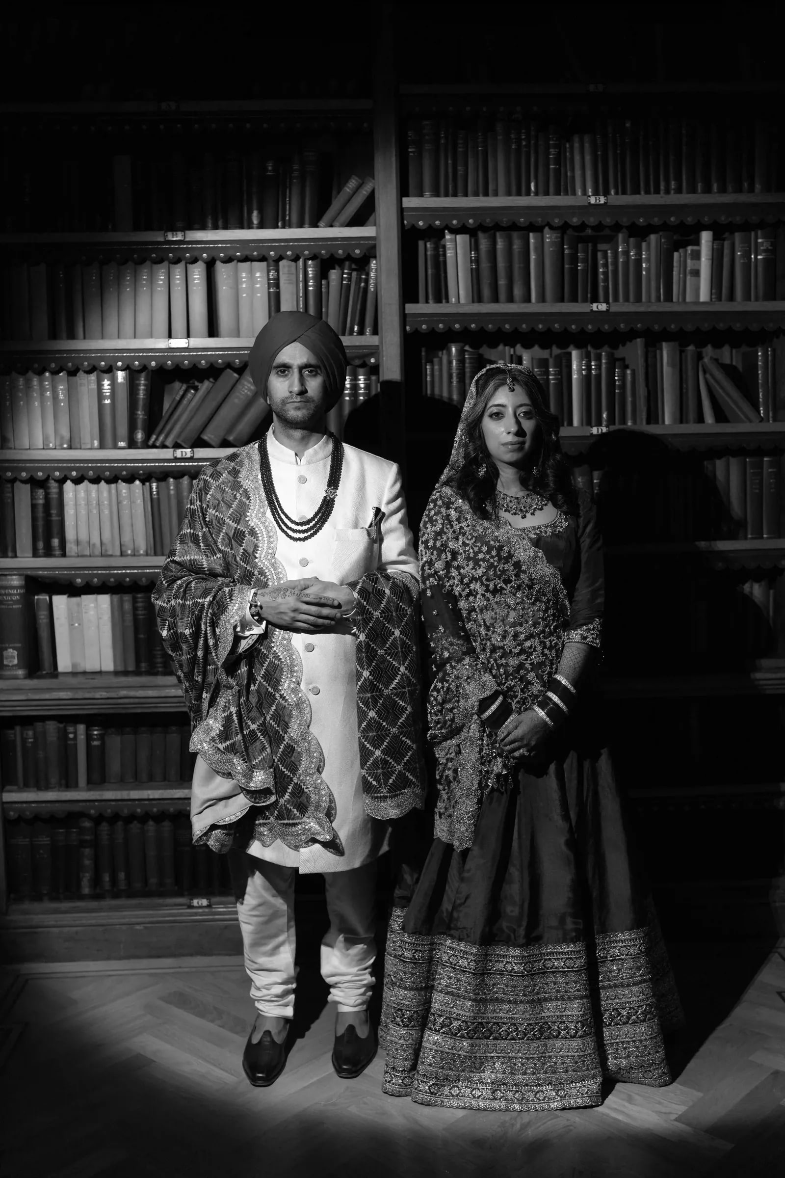 Couple standing together in the library, in black and white