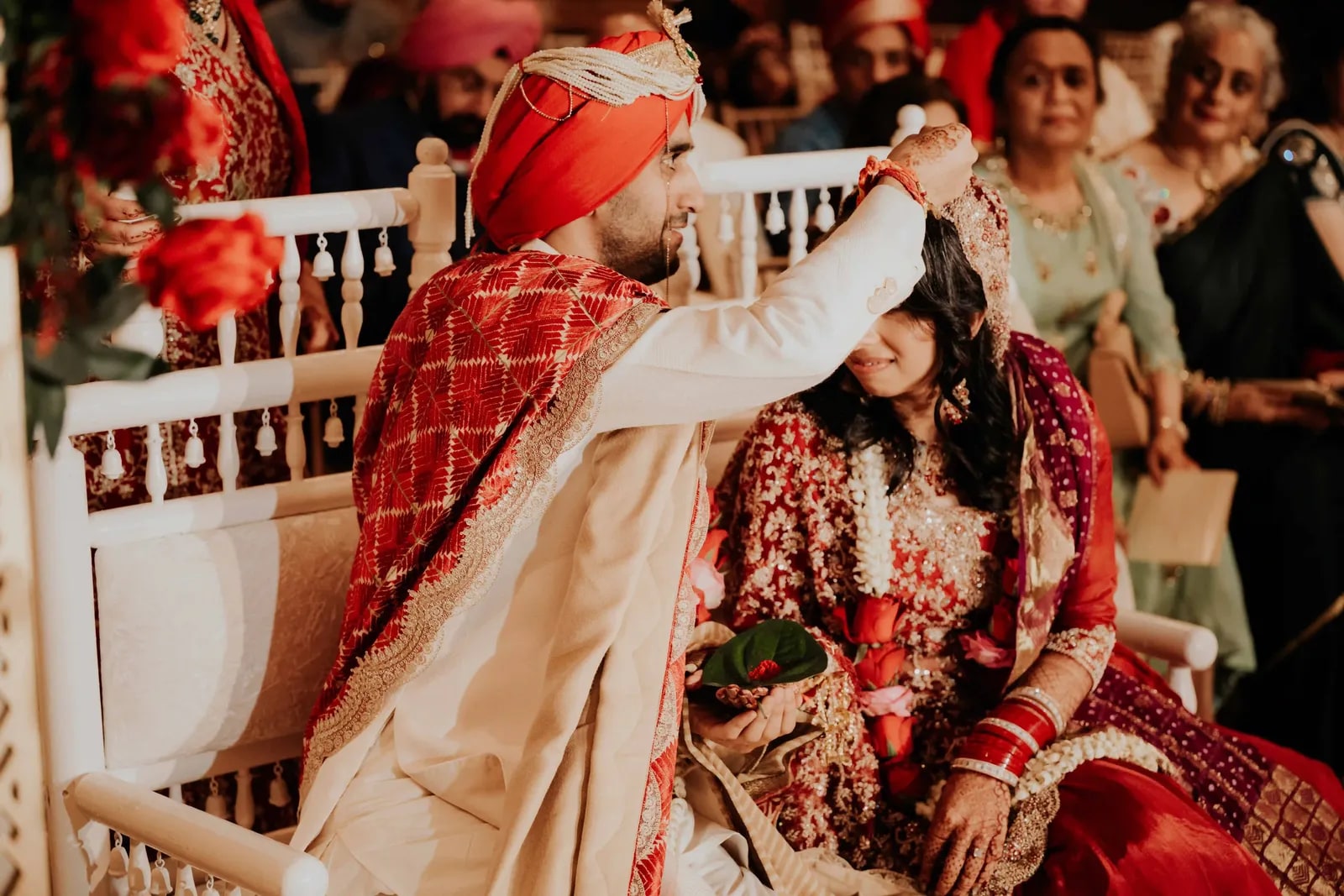 Groom applying the sindoor to his bride's parting during the ceremony