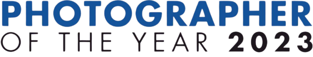 Text displaying "PHOTOGRAPHER OF THE YEAR 2023" in bold blue letters against a black background.