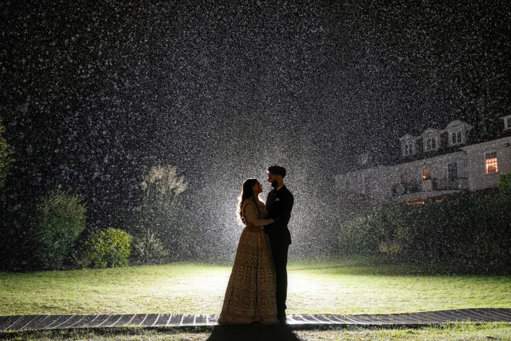 A couple image standing in a rain is captured by asian wedding photographer and videographer