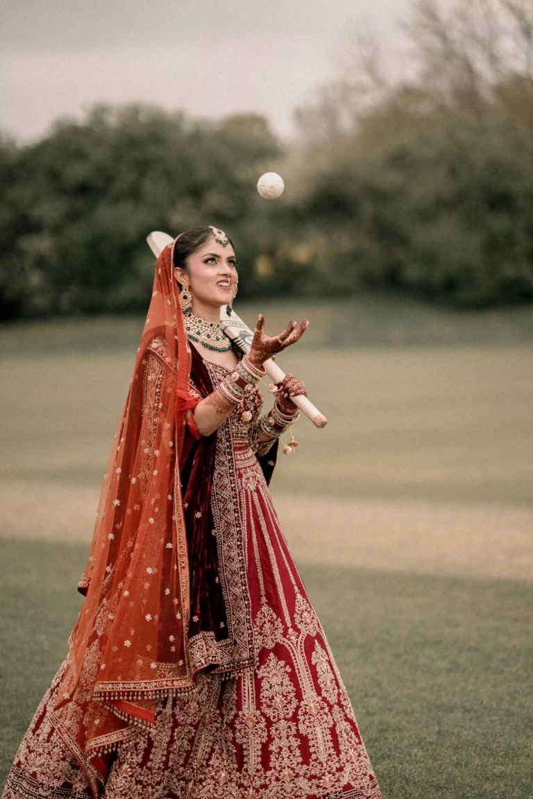 Hindu bride holding ceremonial sword in garden setting
