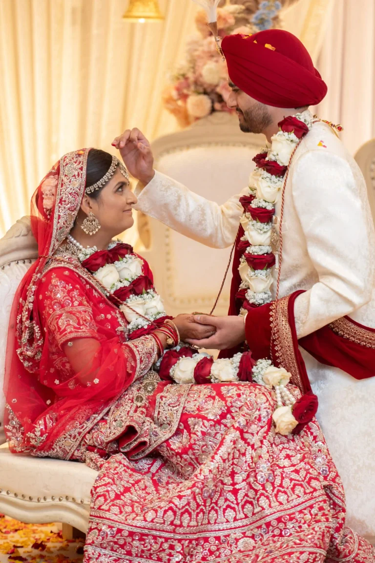 Hindu bride and groom exchanging floral garlands during Varmala ceremony